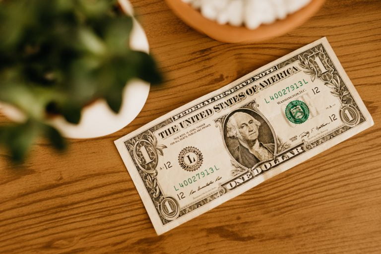An American dollar bill lying on a table.
